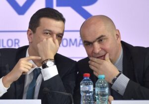 Ilie Bolojan și Sorin Grindeanu discutând despre companiile de stat din România